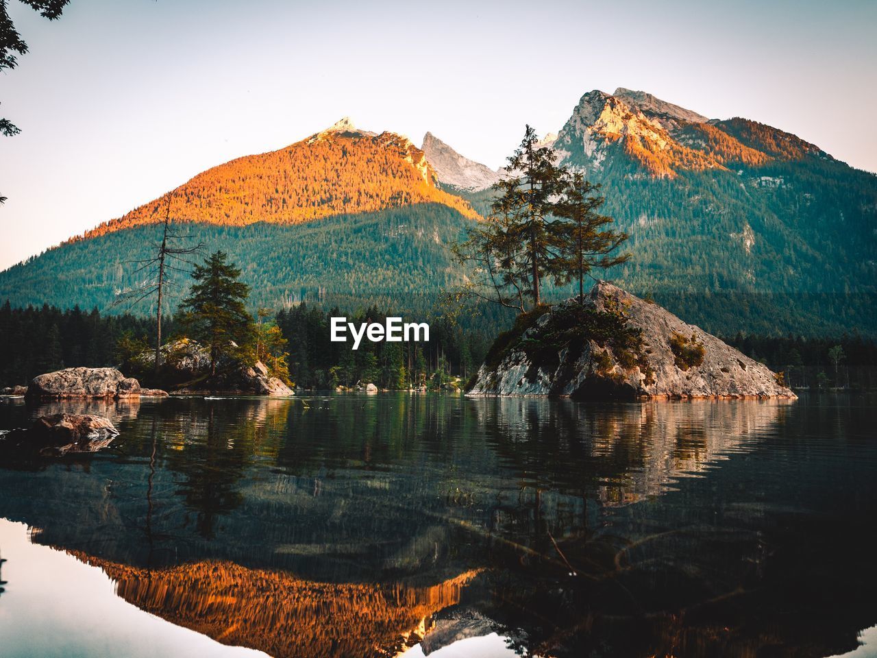 Scenic view of lake and mountains against clear sky