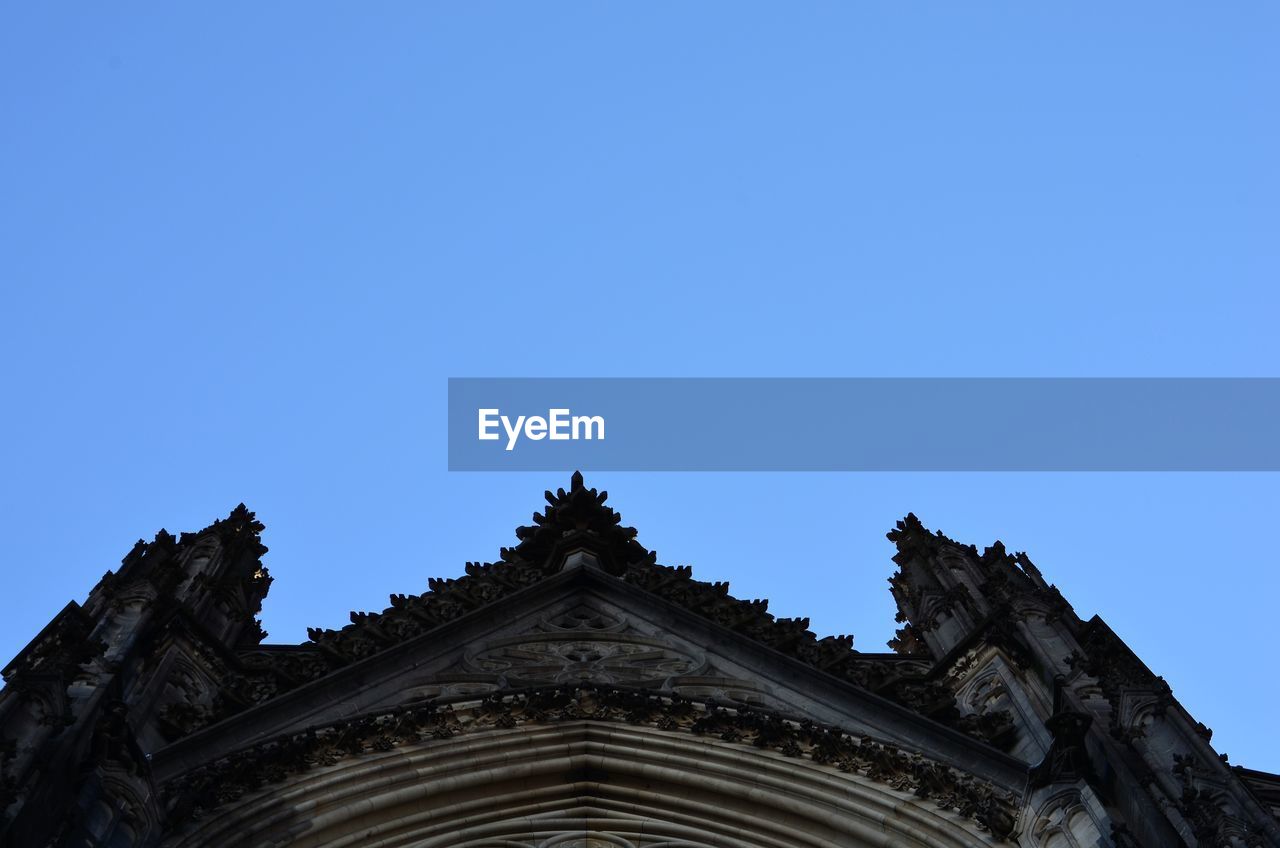 LOW ANGLE VIEW OF CATHEDRAL AGAINST CLEAR BLUE SKY