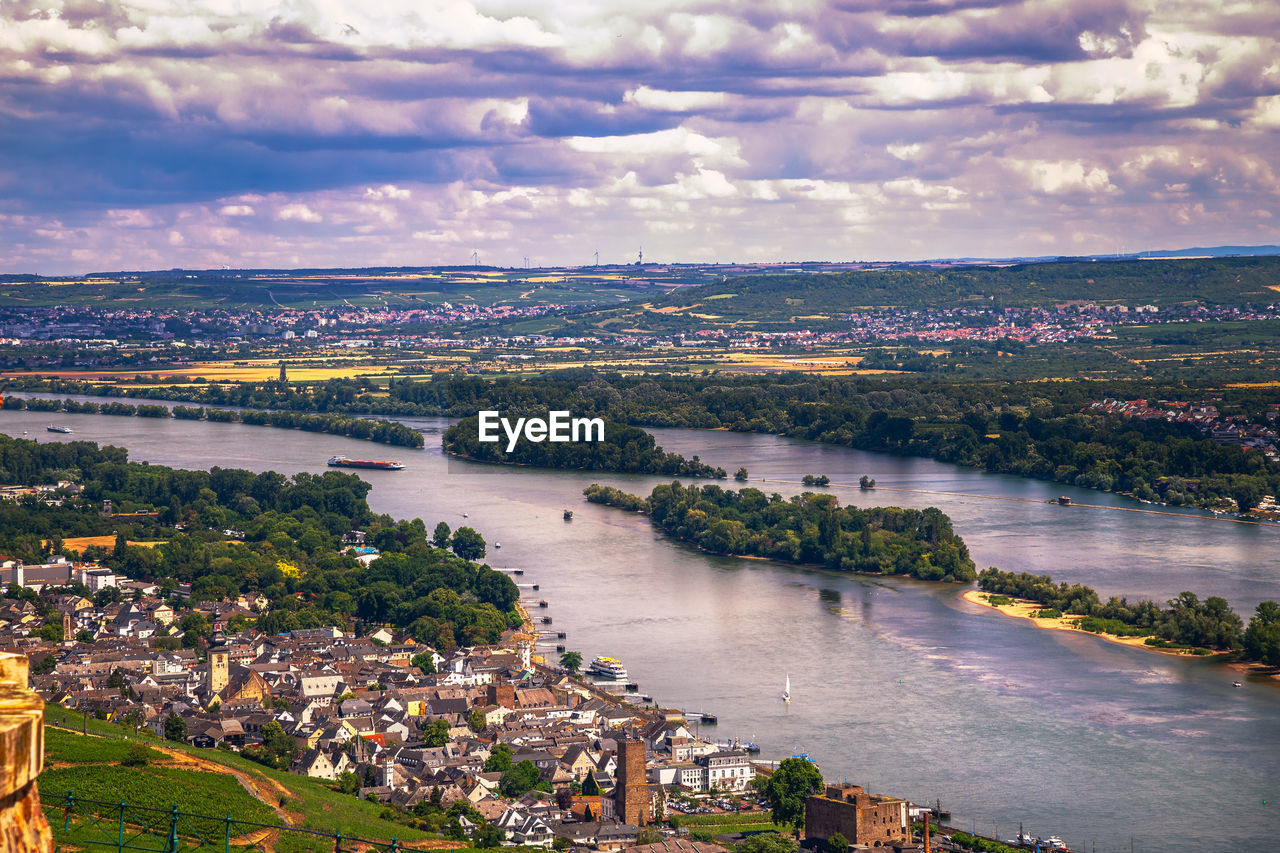 high angle view of river amidst cityscape against sky