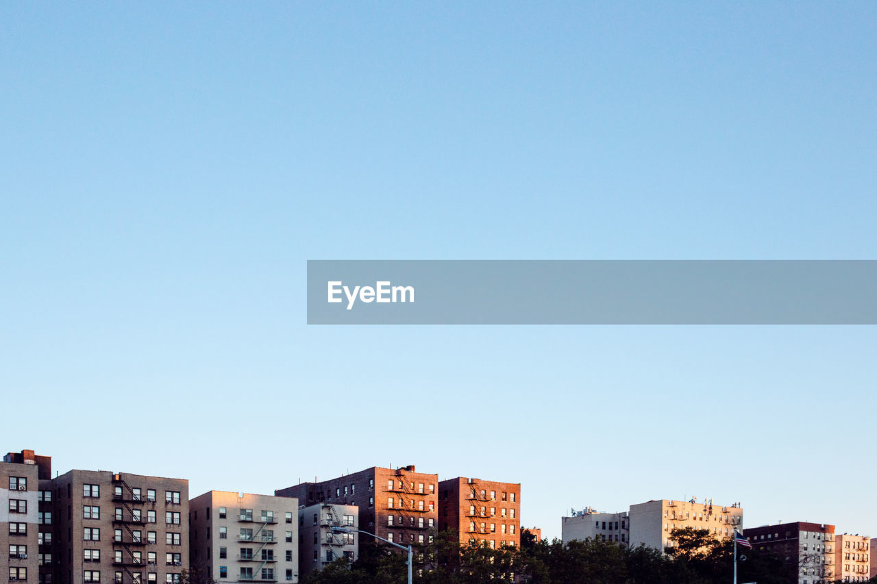 Low angle view of buildings against clear blue sky