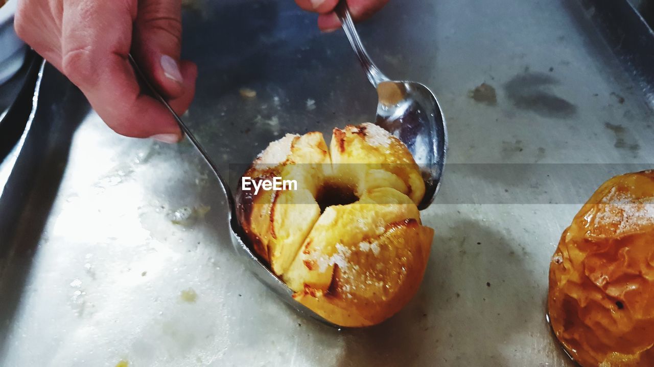 HIGH ANGLE VIEW OF PERSON PREPARING FOOD IN KITCHEN