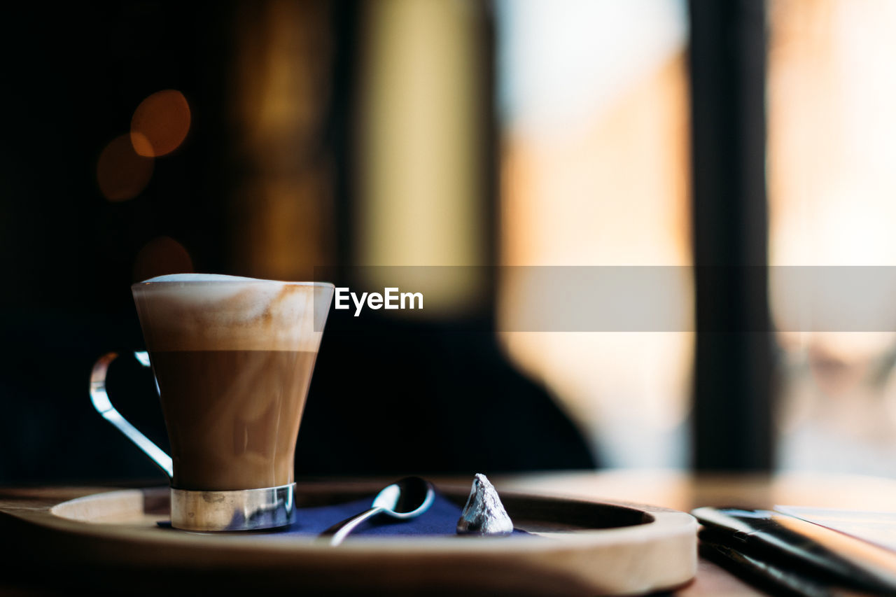 Beautiful setting of cappuccino near window.