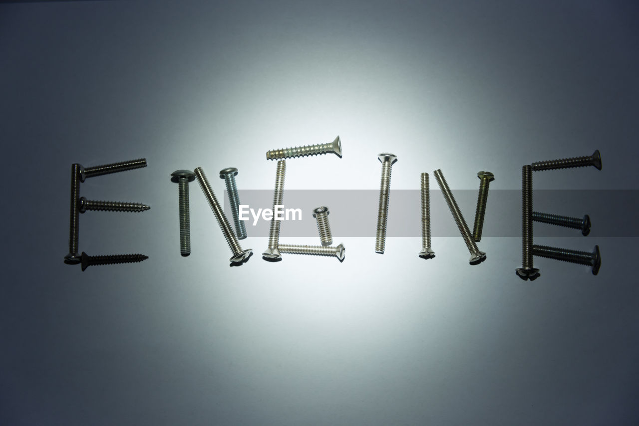 Engine text made by screws on white background