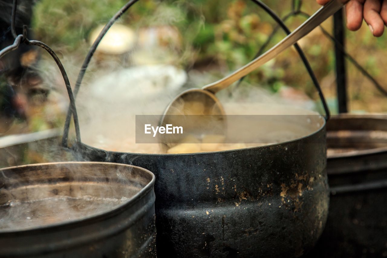 Cropped hand preparing food outdoors