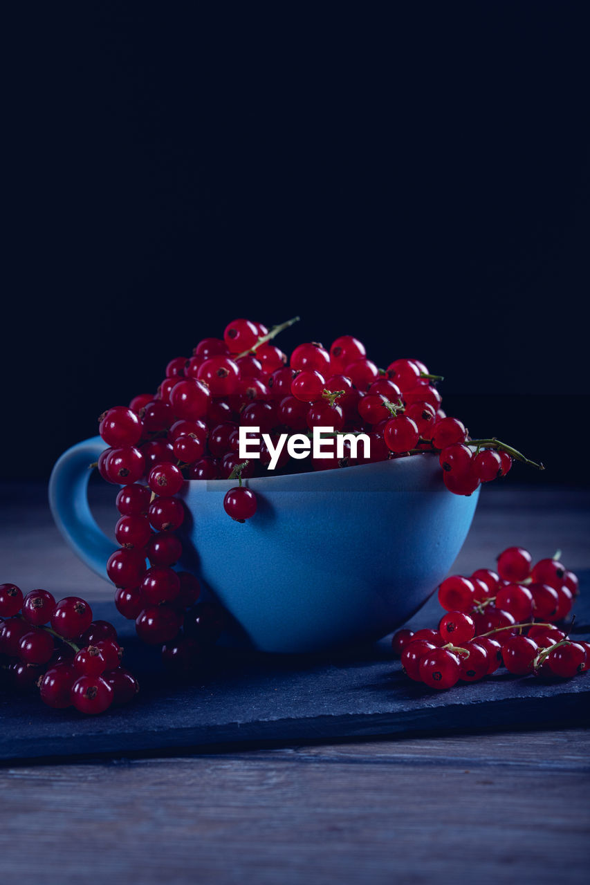 CLOSE-UP OF STRAWBERRIES ON TABLE