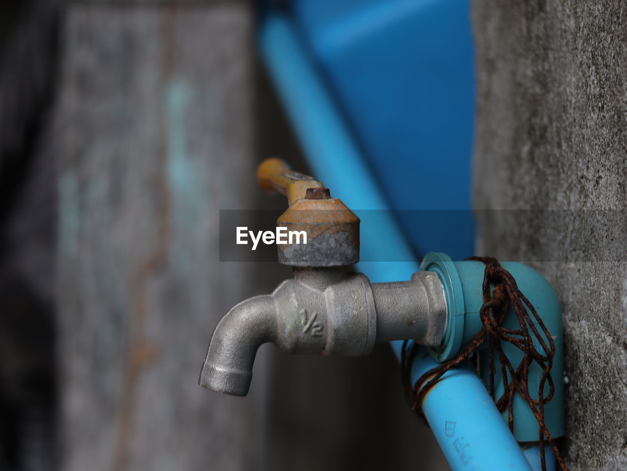 Close-up of rusty pipe against wall