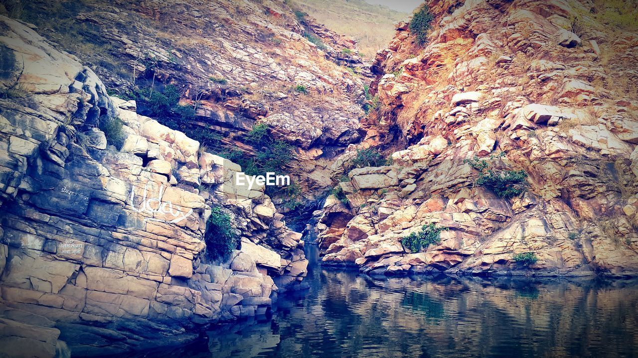 Scenic view of lake by rock formations