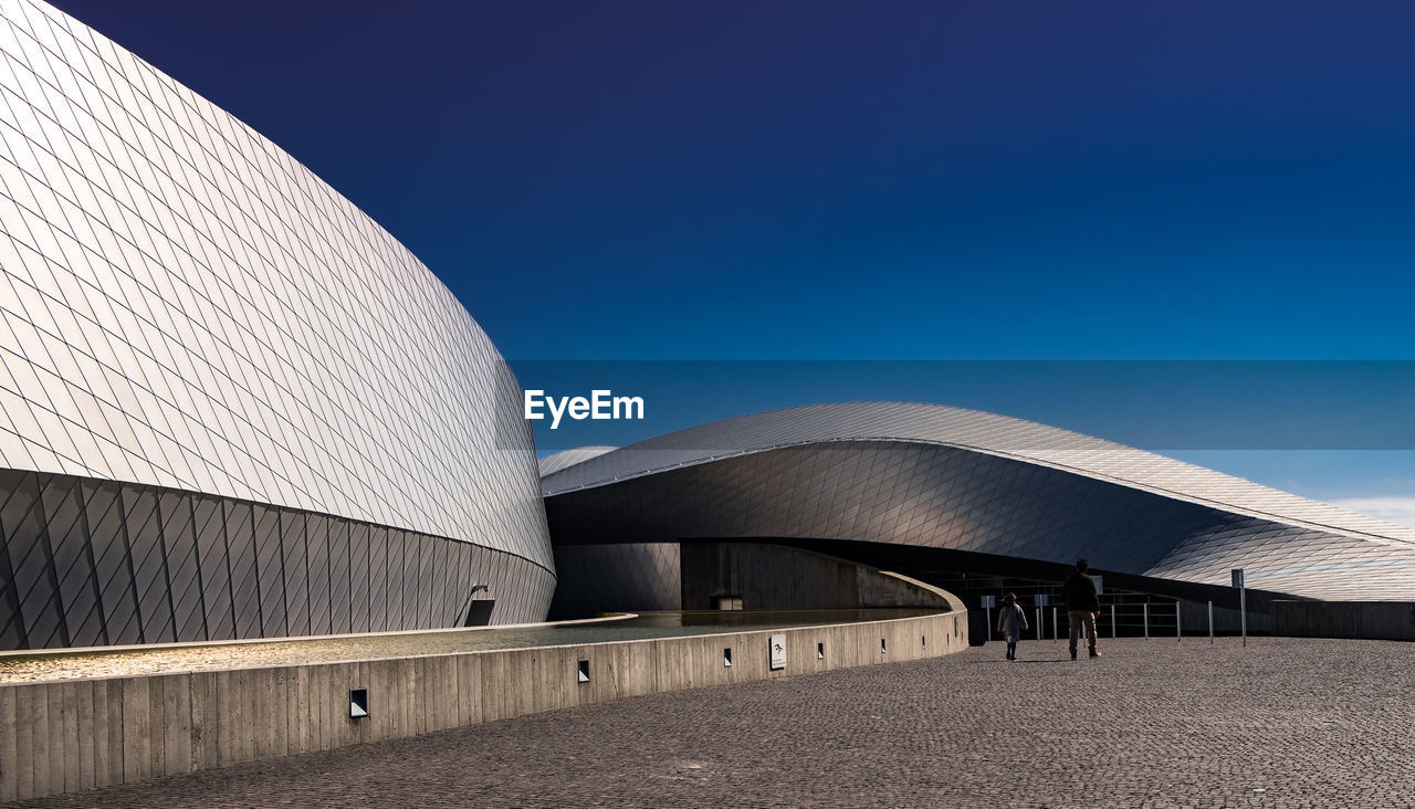 EXTERIOR OF MODERN BUILDINGS AGAINST BLUE SKY