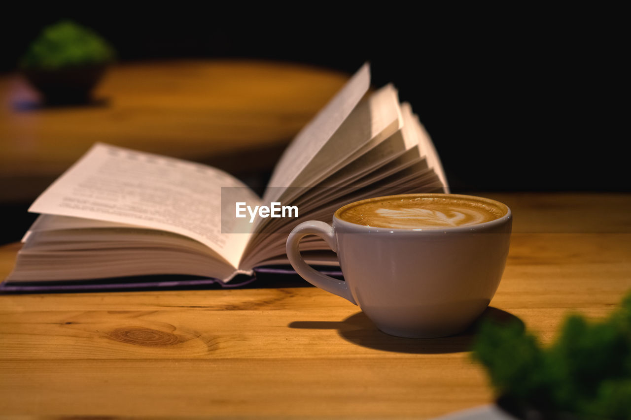 CLOSE-UP OF CUP OF COFFEE ON TABLE