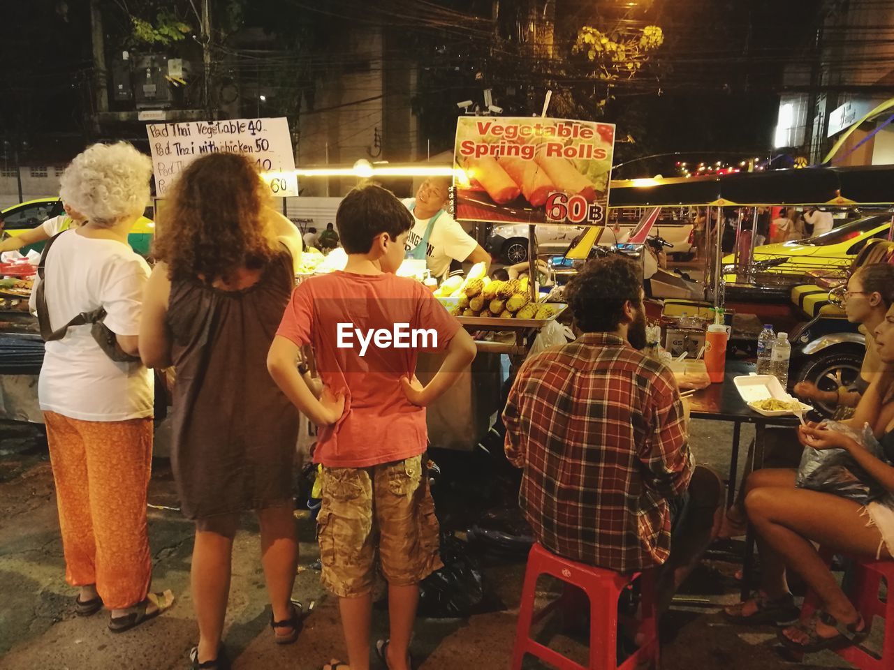 REAR VIEW OF PEOPLE ON STREET MARKET