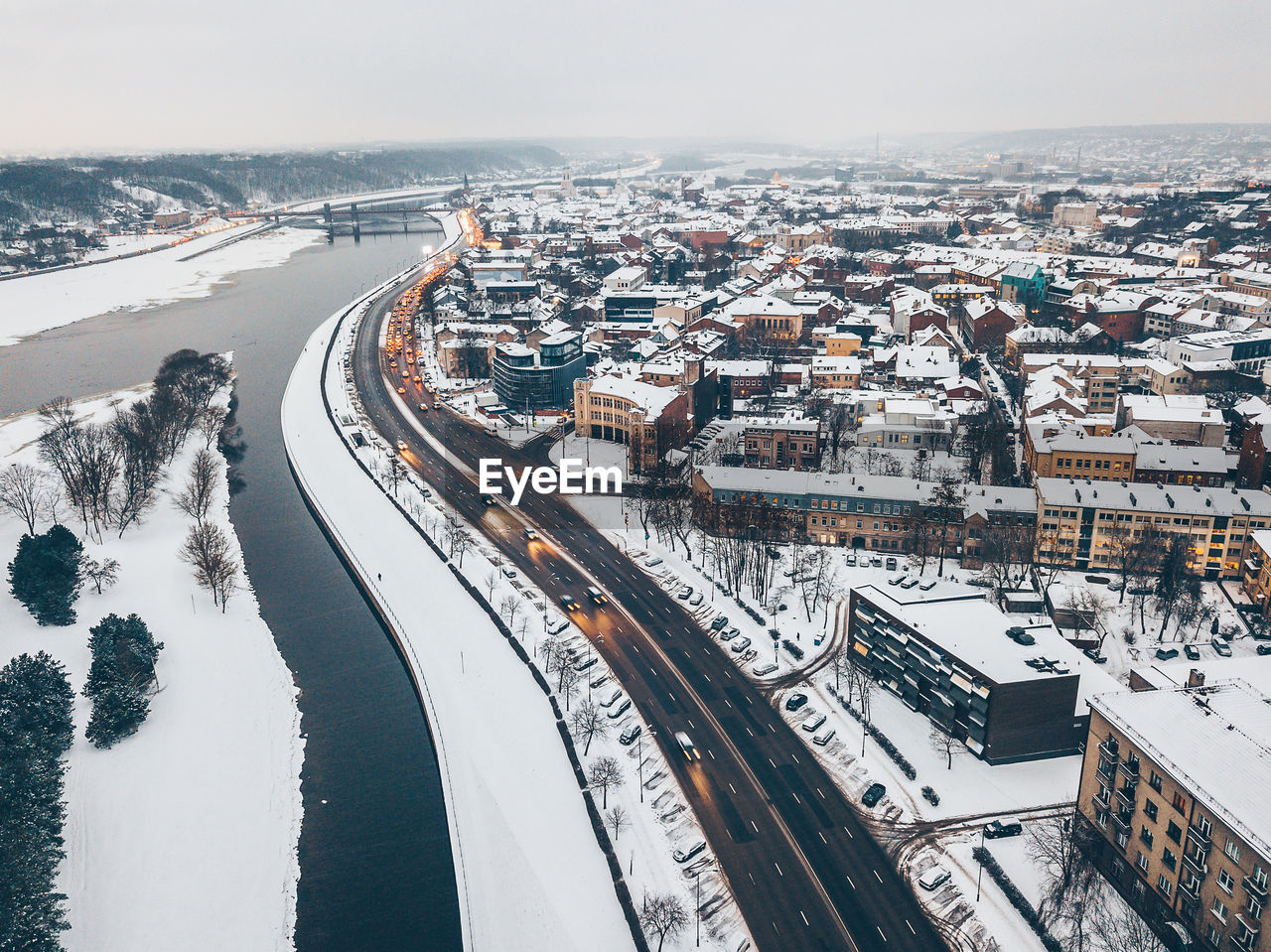 HIGH ANGLE VIEW OF RIVER AMIDST CITY DURING WINTER