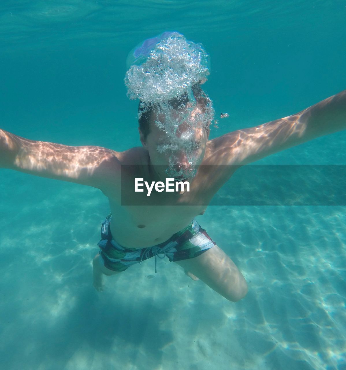 TWO PEOPLE SWIMMING IN POOL