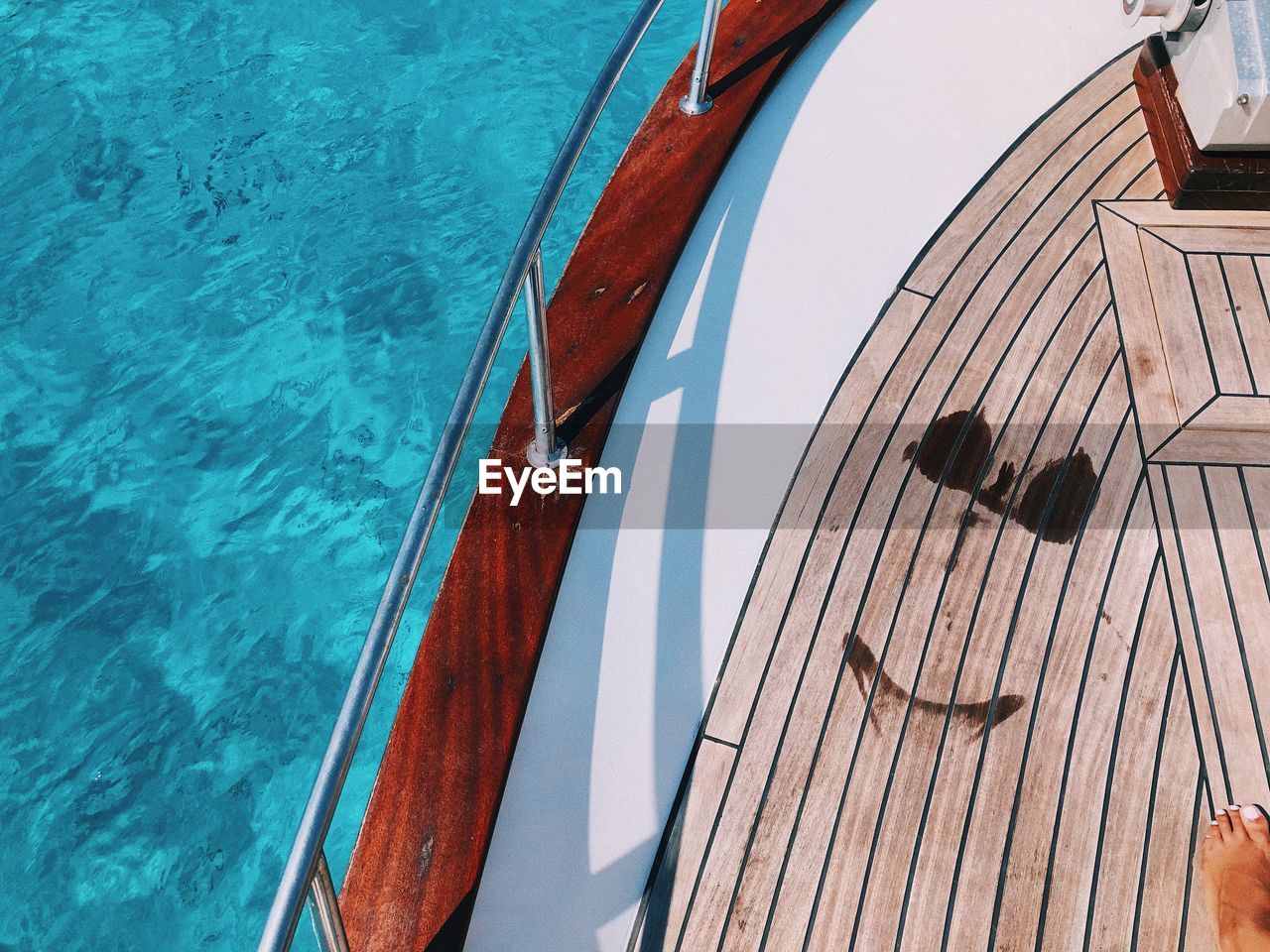 High angle view of  the sea with the mark of a bikini on the boat