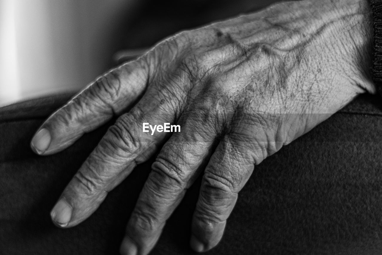Close-up of a hand of an old man, black and white photo
