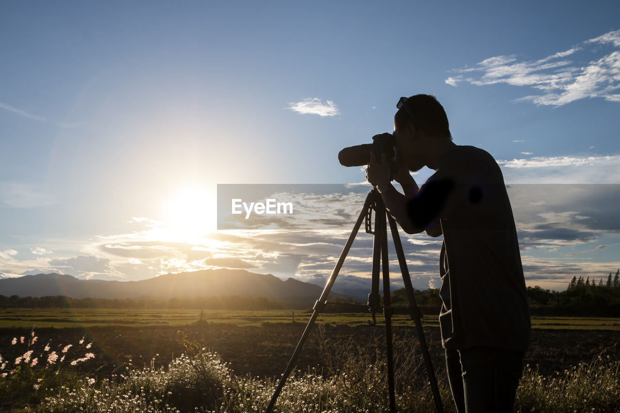 MAN PHOTOGRAPHING ON CAMERA