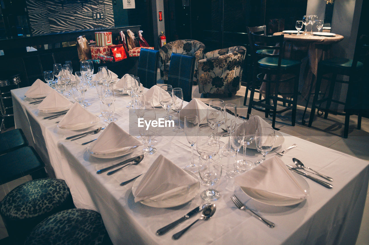 Wineglass and plates arranged on dinning table at restaurant