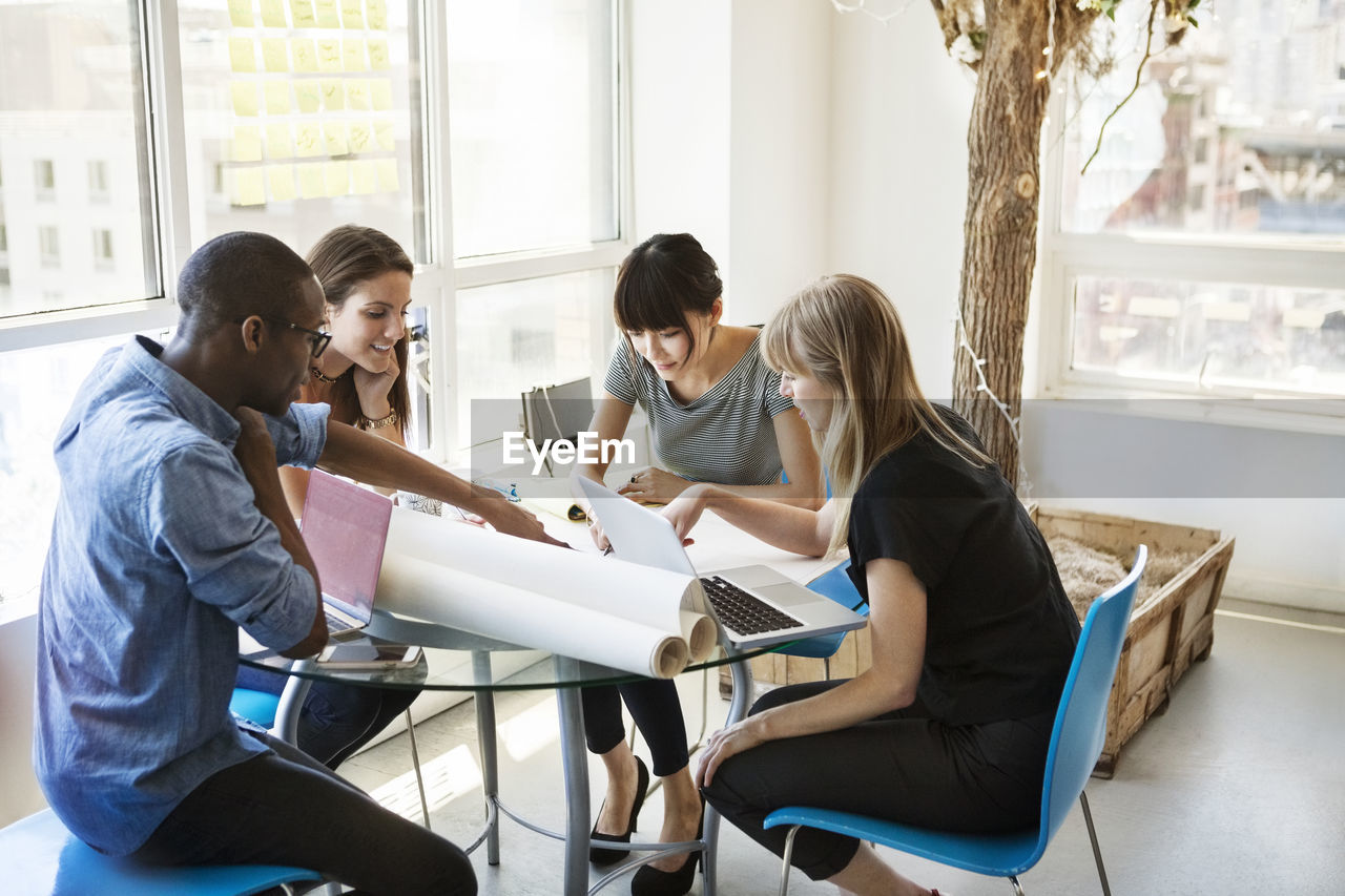 Creative business people discussing on table in office