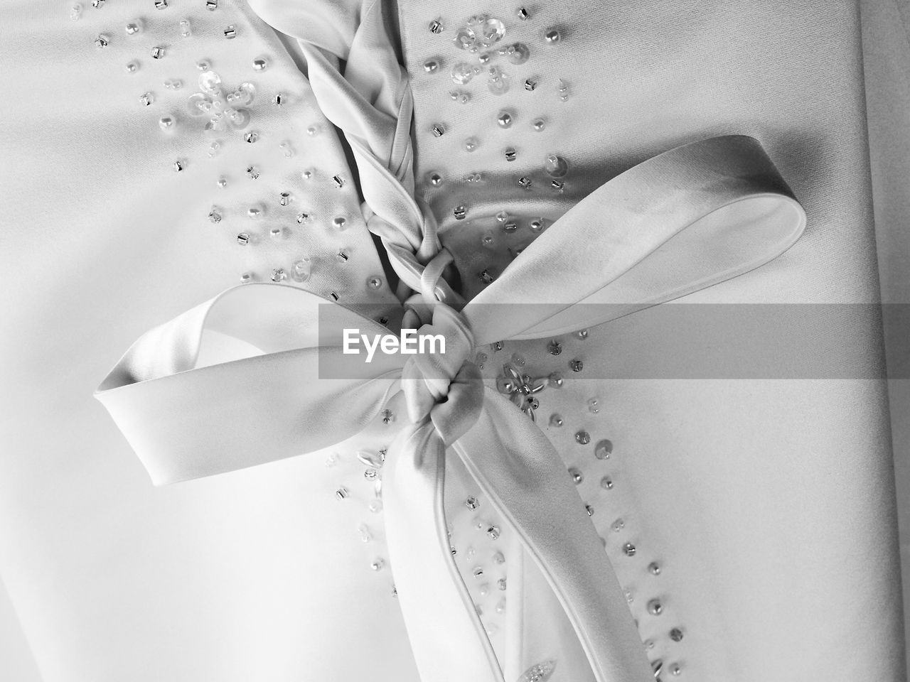 Close-up of tied bow on wedding dress
