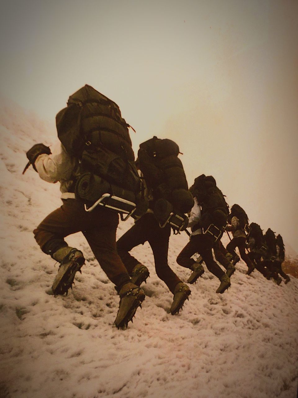 Rear view multiple exposure of a man backpack on snowed slope