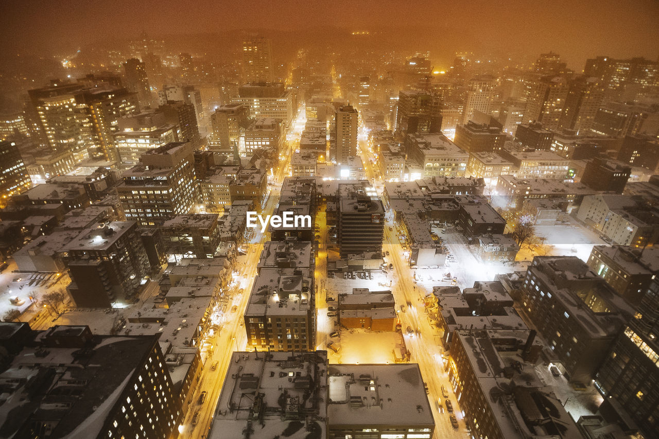 High angle view of illuminated buildings in city at night