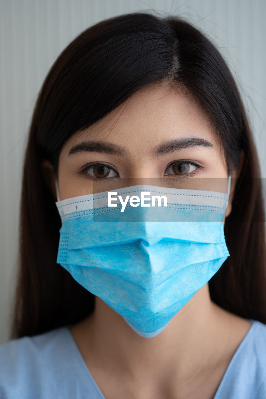 Portrait of young woman wearing mask