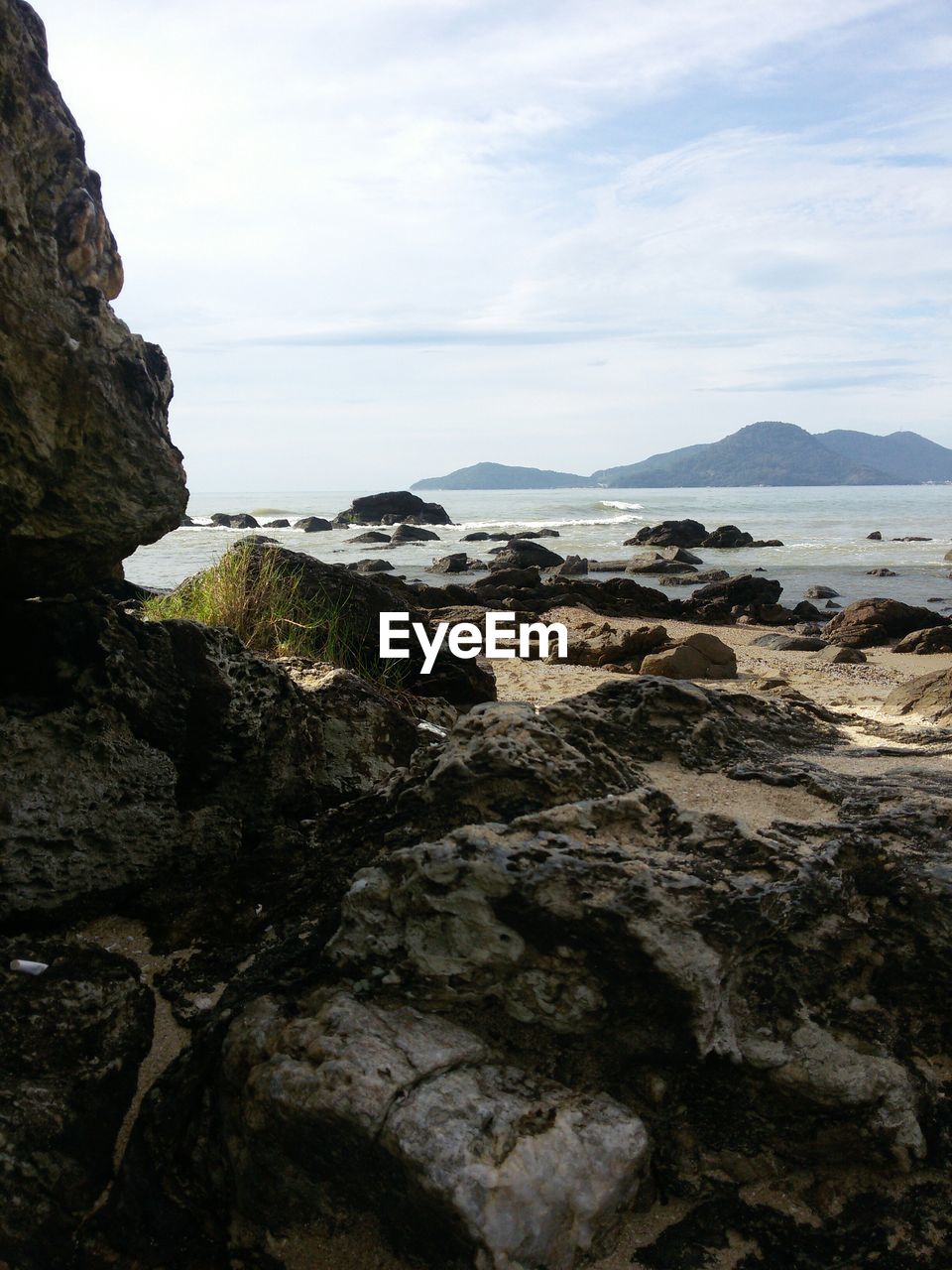 Scenic view of sea against cloudy sky