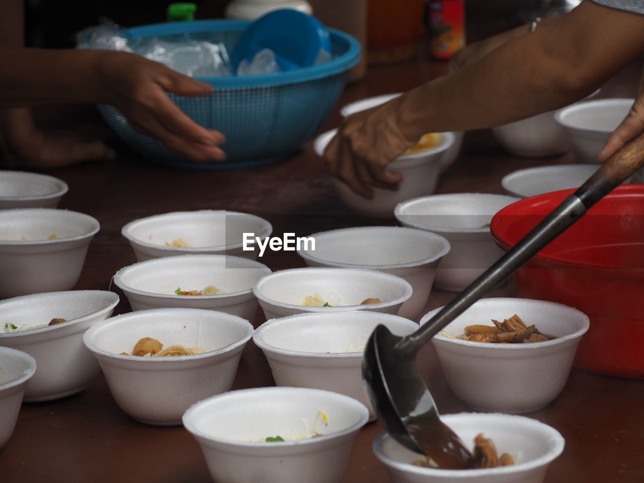 Cropped image of women preparing food on table