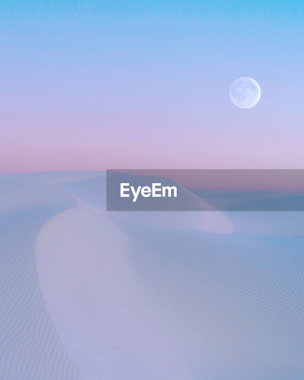 Scenic view of sand dunes in desert against sky during sunset