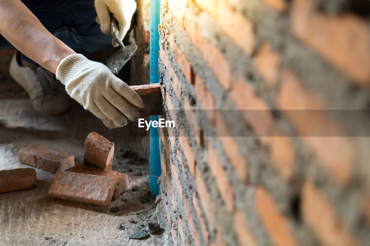 MIDSECTION OF MAN WORKING ON METAL