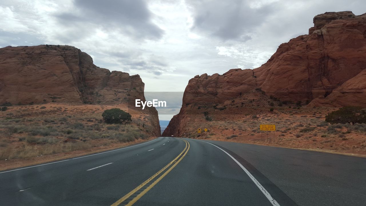 VIEW OF ROAD PASSING THROUGH MOUNTAIN