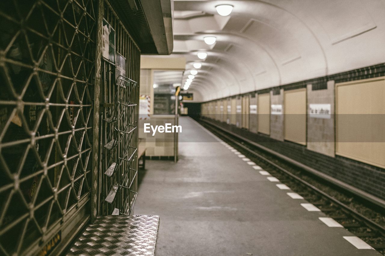 Empty illuminated railroad station platform