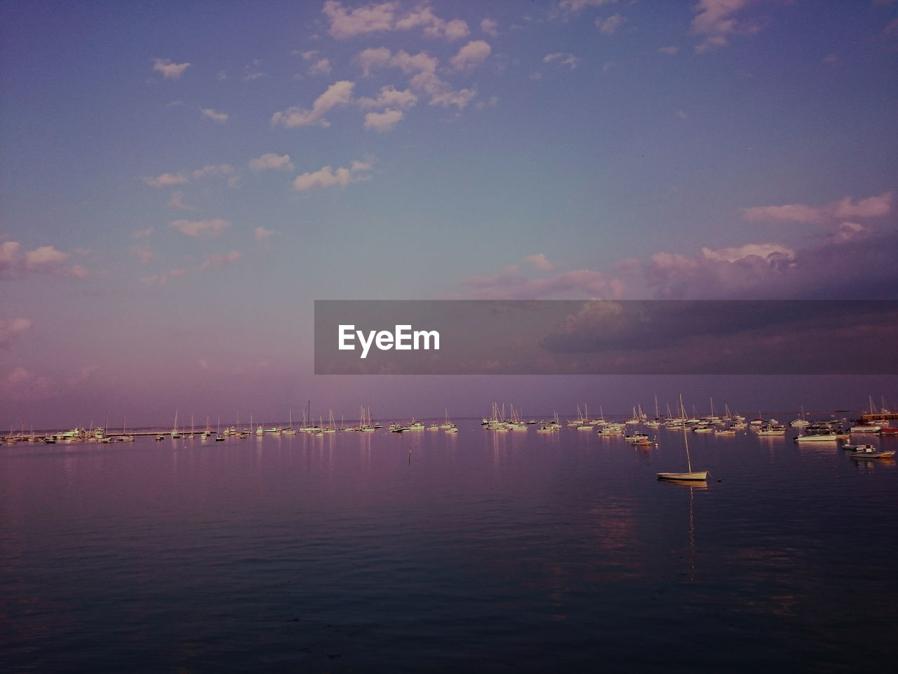 Sailboats in sea against sky