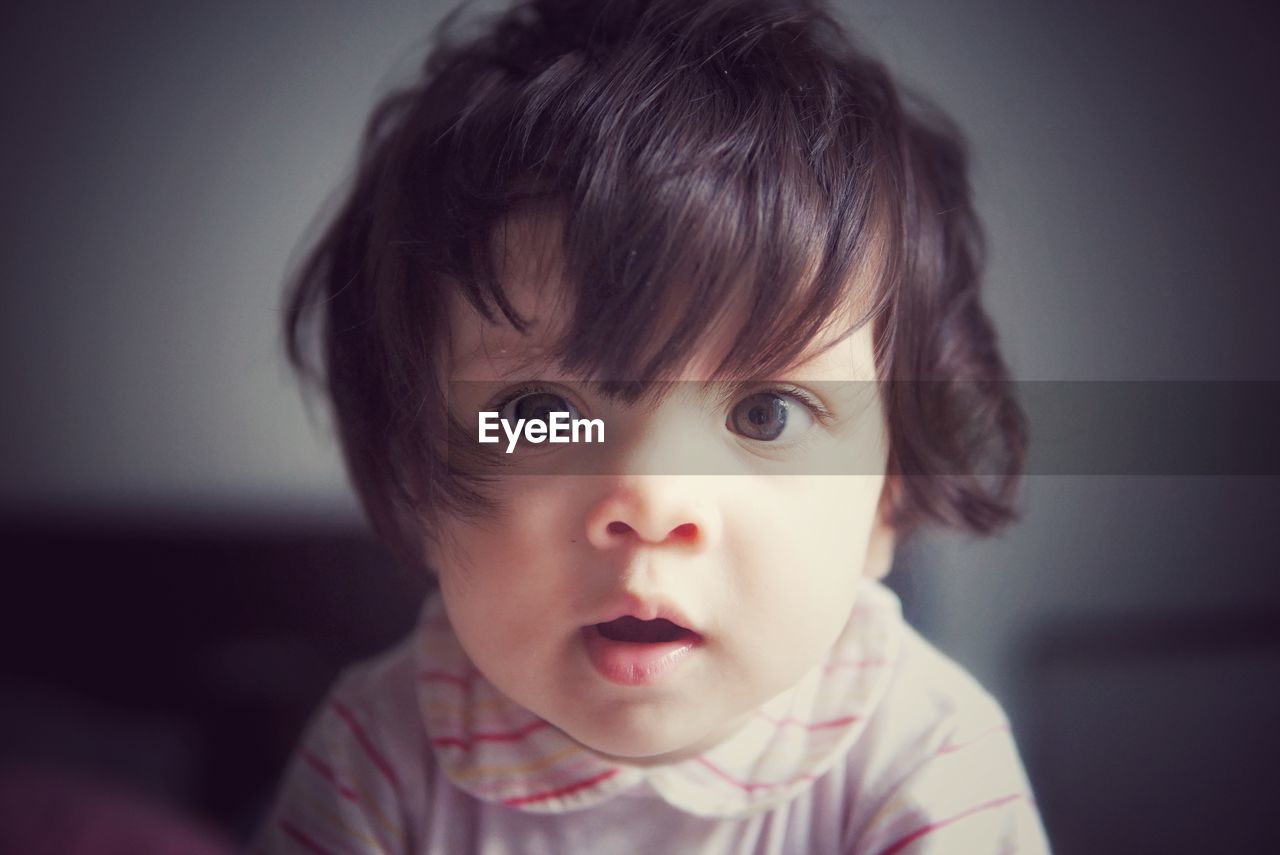 Close-up portrait of cute baby girl at home