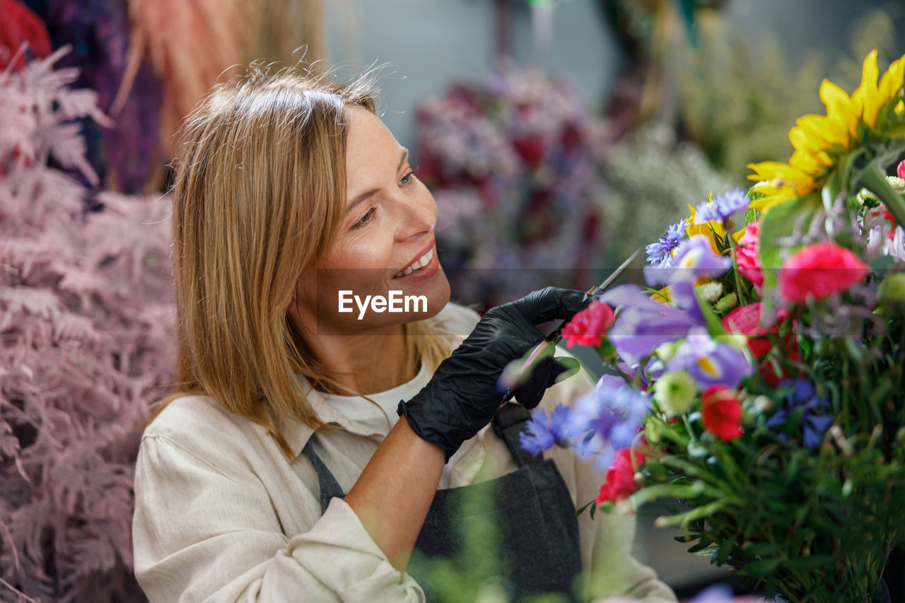 close-up of woman with flowers blooming outdoors