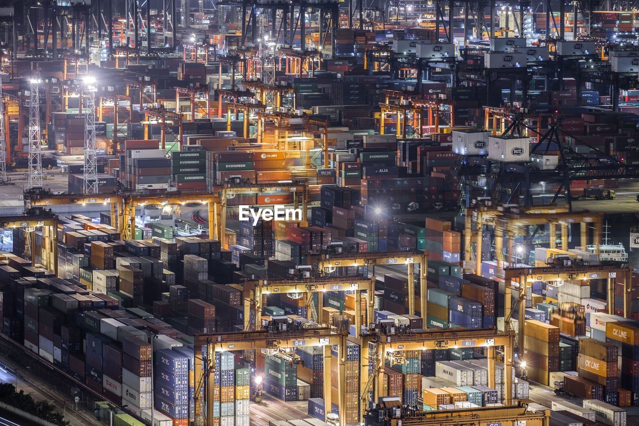 High angle view of illuminated cargo containers at commercial dock