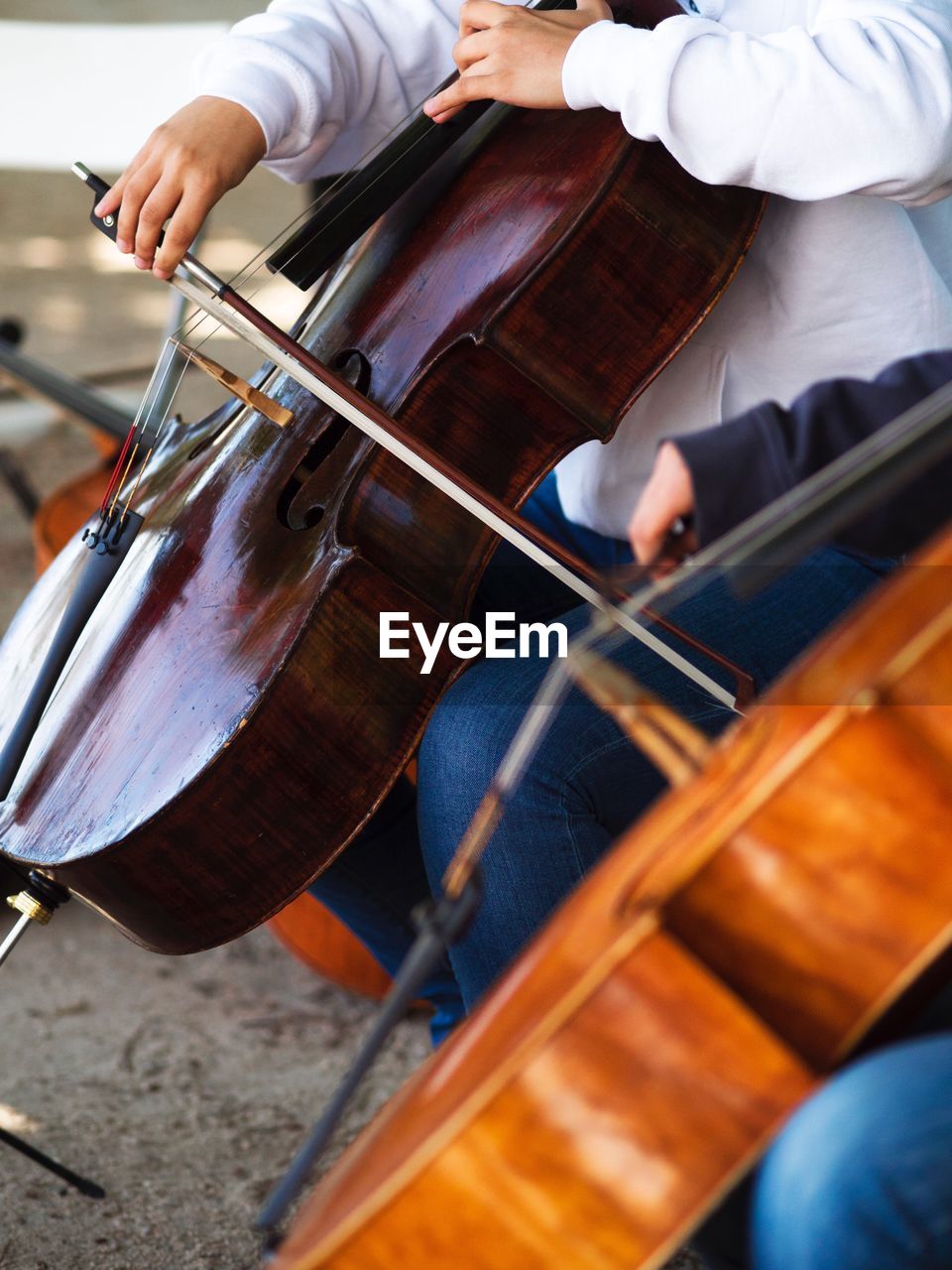 Midsection of people playing violin