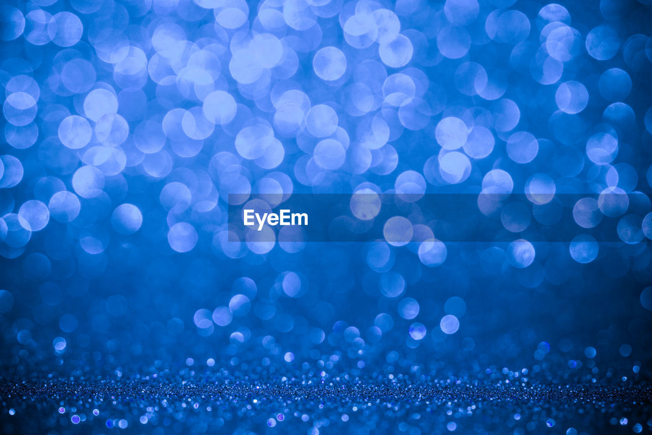 A white bokeh over the blue background.