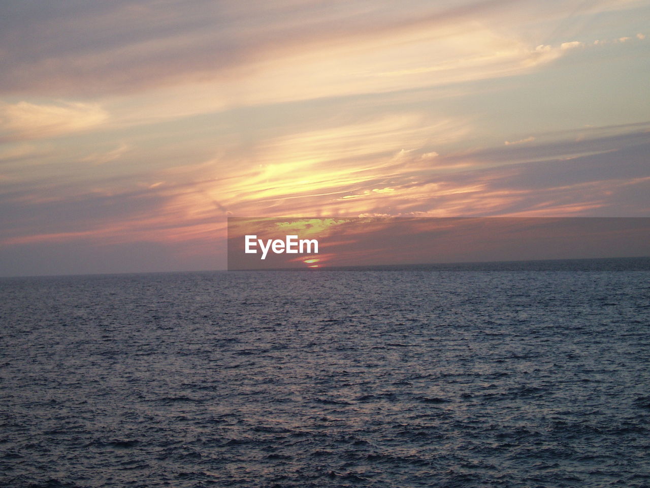 SCENIC VIEW OF SEA AT SUNSET