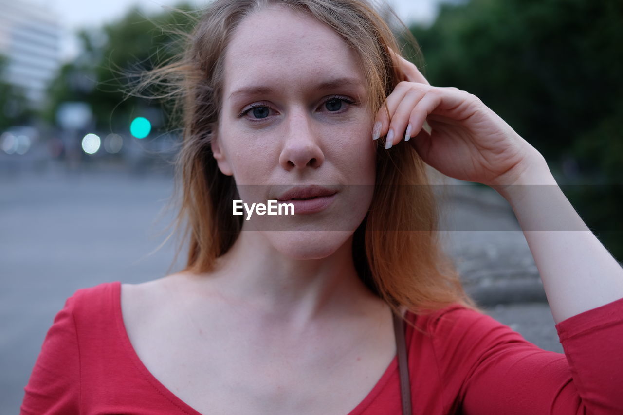 Portrait of young woman in city