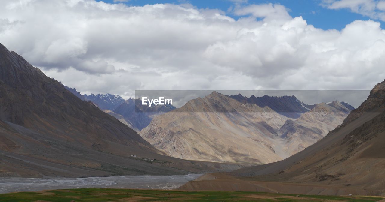 Idyllic shot of river and mountains against sky