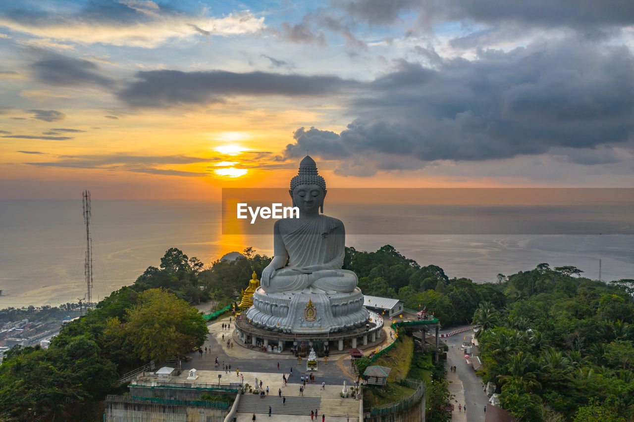 STATUE AGAINST TEMPLE DURING SUNSET