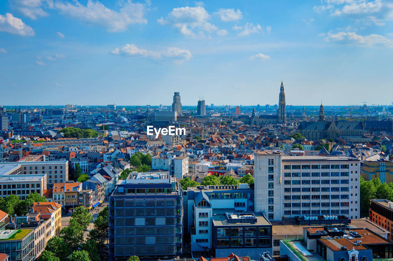 architecture, city, built structure, building exterior, skyline, cityscape, urban area, building, metropolitan area, sky, horizon, metropolis, landscape, travel destinations, urban skyline, office building exterior, nature, downtown, skyscraper, landmark, neighbourhood, travel, residential district, cloud, high angle view, aerial photography, city life, tower block, residential area, bird's-eye view, crowd, aerial view, business finance and industry, town, outdoors, tourism, street, downtown district, blue, tower, office, crowded, city street, daytime, transportation, road, roof, construction industry, environment, business, sunset, dusk