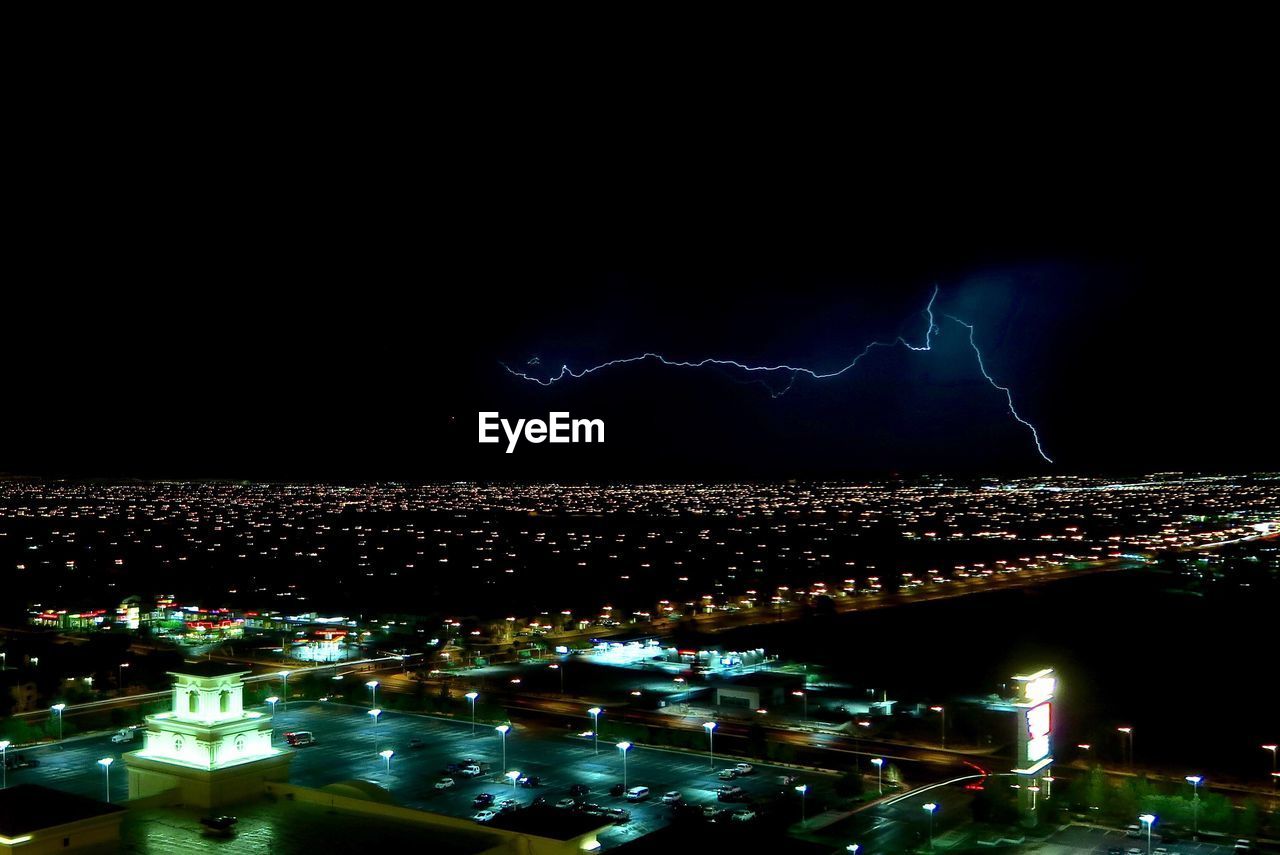 AERIAL VIEW OF ILLUMINATED CITY AT NIGHT