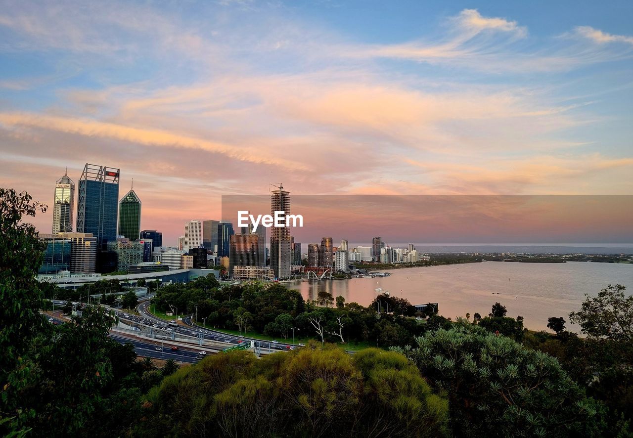 architecture, city, sky, built structure, horizon, building exterior, skyline, sunset, landscape, building, urban skyline, office building exterior, skyscraper, cityscape, water, dusk, nature, travel destinations, cloud, travel, evening, urban area, plant, sea, residential district, tree, transportation, environment, downtown district, business finance and industry, landmark, business, outdoors, coast, scenics - nature, tower, tourism, city life, no people, night, office, industry, beauty in nature, twilight, high angle view, reflection, illuminated, street, land, construction industry, blue, panoramic, arts culture and entertainment
