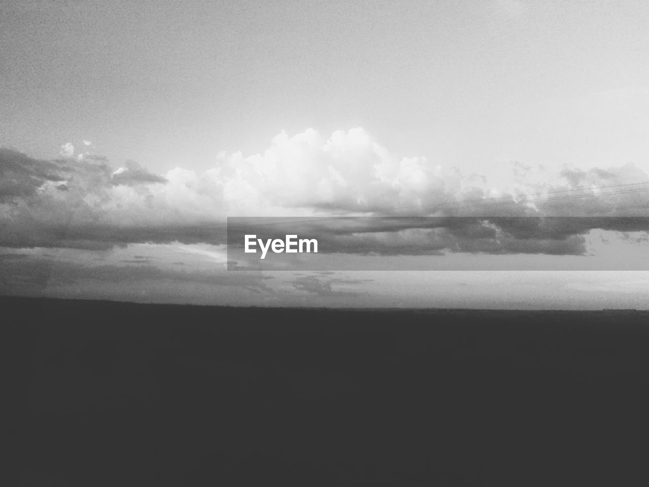 Sea against cloudy sky at dusk