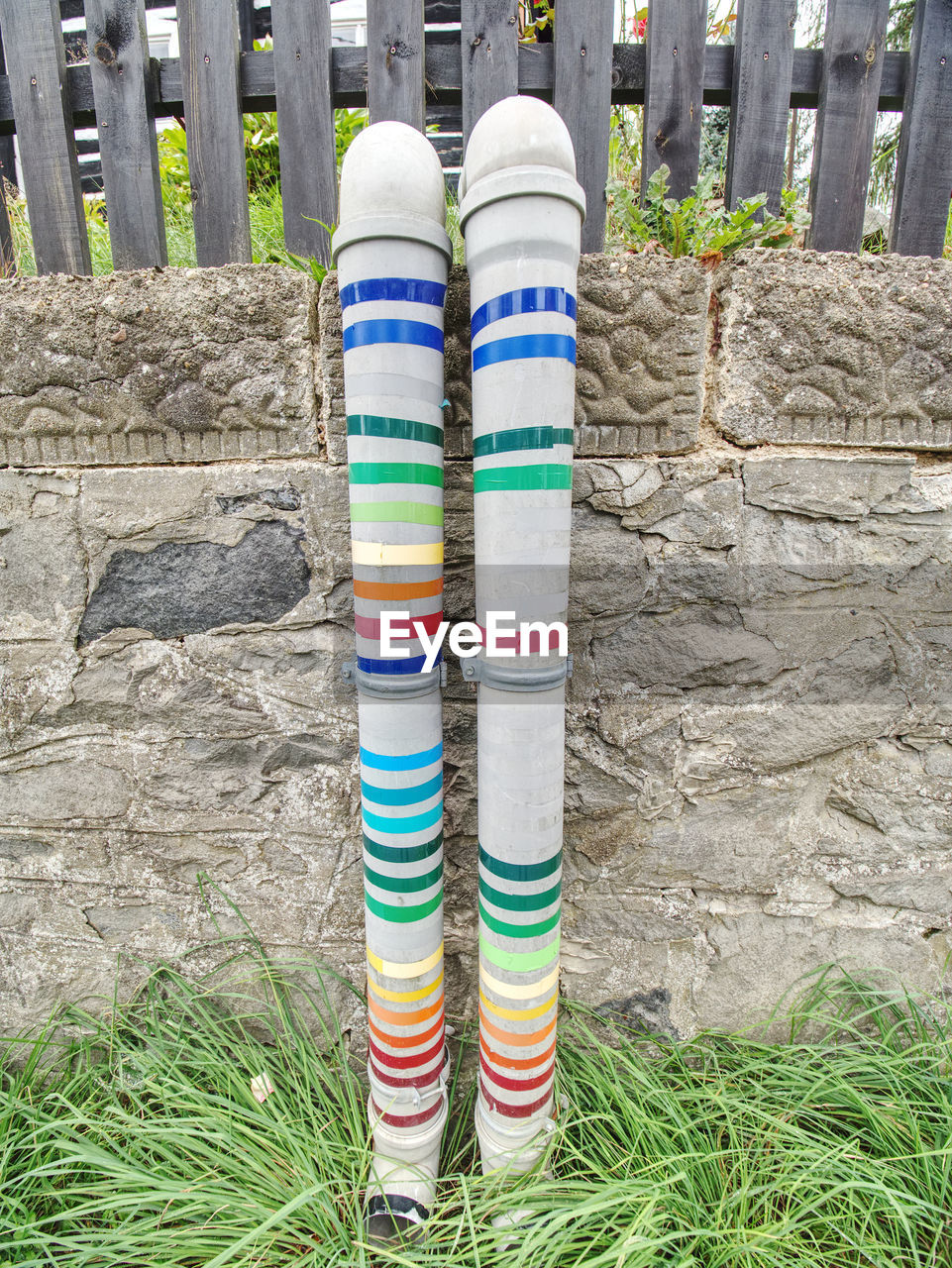 CLOSE-UP OF MULTI COLORED UMBRELLAS ON WALL