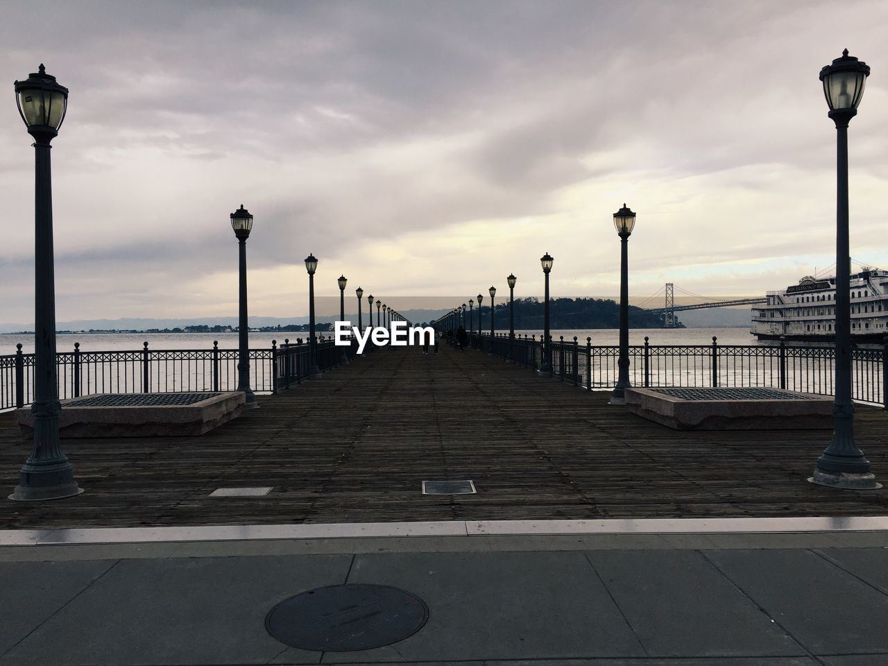Pier on sea against sky during sunset
