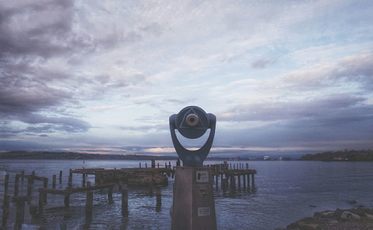 PIER ON SEA AGAINST CLOUDY SKY