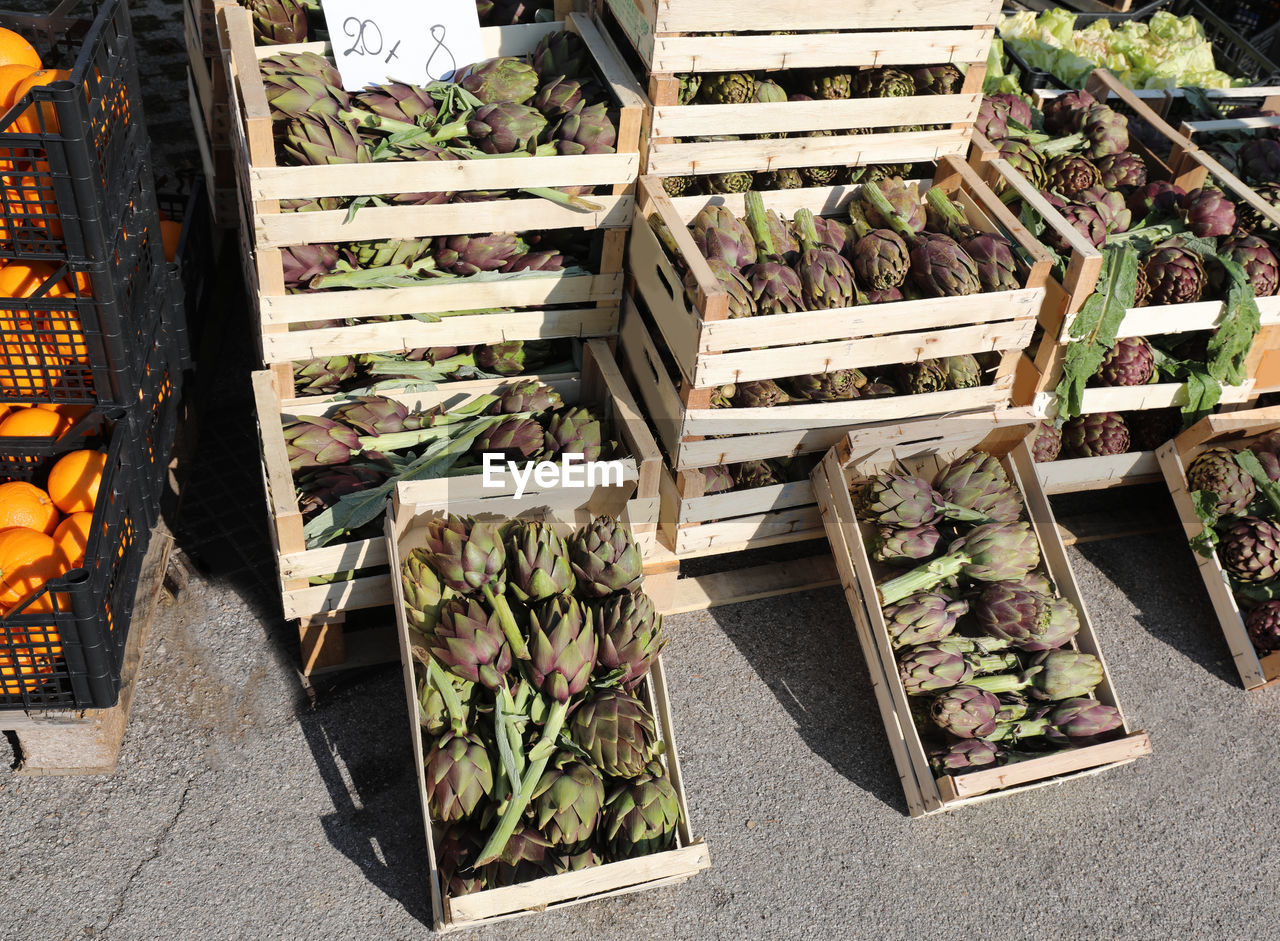 Boxes with big artichokes for sale in the street stall with the price tag