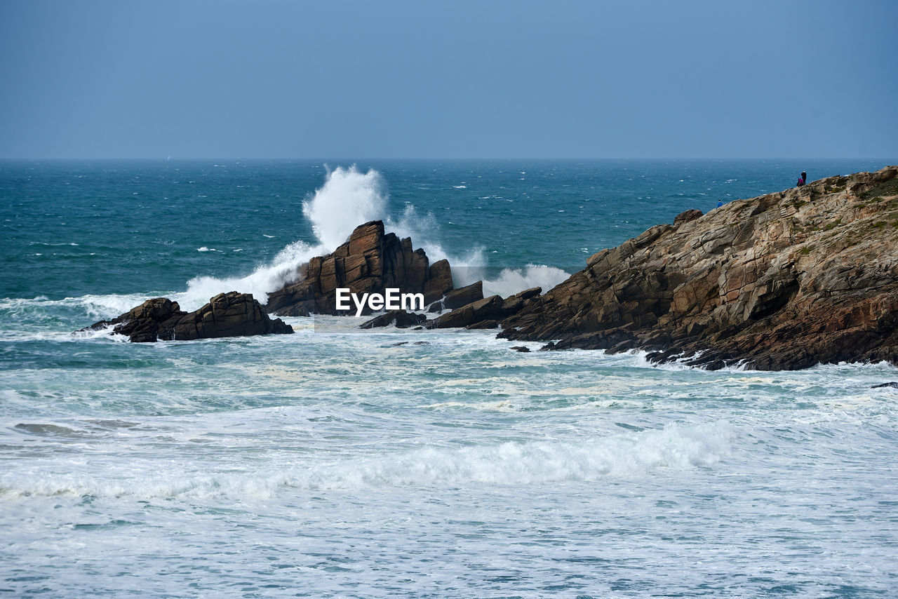 Waves of the atlantic ocean break on a rock with splashing gout  on quiberon in brittany in france 